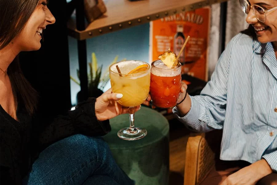 Deux jeunes femmes trinquant avec un cocktail au restaurant Monkey Place à La Roche-sur-Yon